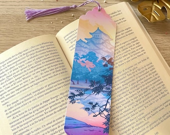 May include: A colourful bookmark featuring a Japanese-style illustration of a pagoda, trees, and a mountain range. The bookmark has a pink, blue, and purple gradient background with a tassel.