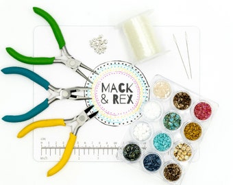 May include: A set of jewelry making supplies including three pairs of pliers, a spool of clear thread, a ruler, two needles, a container of assorted beads, and a circular card with the text "Mack & Rex".