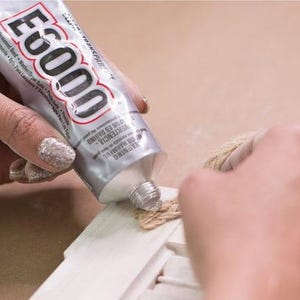 image of the a person applying the E6000 Craft Adhesive 3.7oz Clear Industrial-Strength Glue on a object.





E6000 Craft Adhesive | 3.7oz Clear Industrial-Strength Glue for Jewelry Making, Rhinestones, Beadwork, Leather, Fabric, and DIY Crafts
