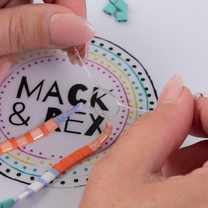 image of a person making a bracelet while the wipeable bead mat is on the table. 







Wipeable Bead Mat with Built-in Measuring Tape | Non-Slip Jewelry Making Tool | Perfect Beading Mat for DIY Projects