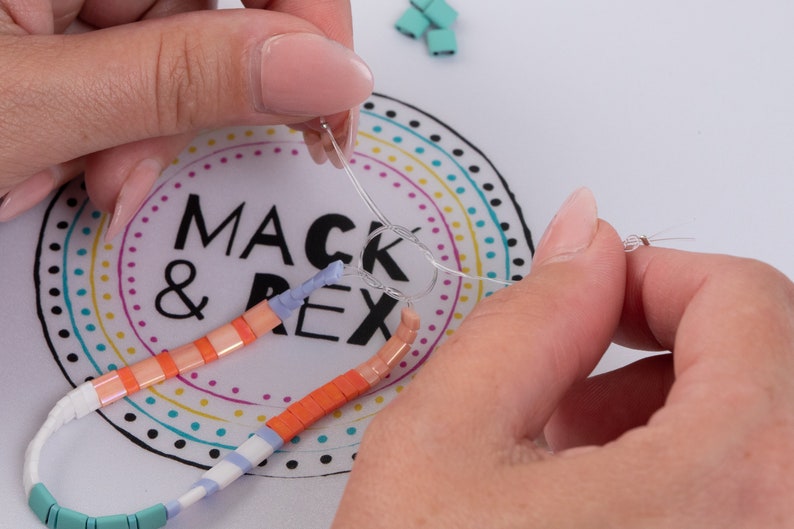 image of a person making a bracelet while the wipeable bead mat is on the table. 







Wipeable Bead Mat with Built-in Measuring Tape | Non-Slip Jewelry Making Tool | Perfect Beading Mat for DIY Projects