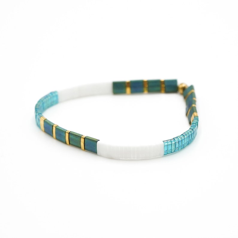 a blue and white bracelet with gold accents in a white background













Shoreline Mix & Match Tila Bead Bracelets for Women | High Quality Stacking Bracelet | Boho Stretch Bracelet | Waterproof Miyuki Tila Beads