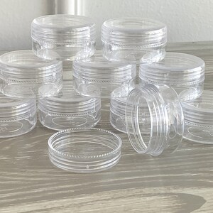 image of the Round Bead Containers 25-Pack on a table. 






Round Bead Containers 25-Pack | Clear Plastic Storage Jars with Twist Lids, 1.5 Inch Diameter Bead Storage Box for Jewelry & DIY Craft Kits