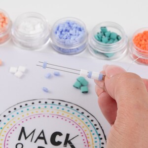 image of a person making a bracelet while using the wipeable bead mat with built-in measuring tape. 








Wipeable Bead Mat with Built-in Measuring Tape | Non-Slip Jewelry Making Tool | Perfect Beading Mat for DIY Projects