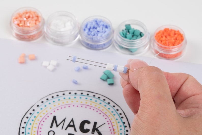 image of a person making a bracelet while using the wipeable bead mat with built-in measuring tape. 








Wipeable Bead Mat with Built-in Measuring Tape | Non-Slip Jewelry Making Tool | Perfect Beading Mat for DIY Projects