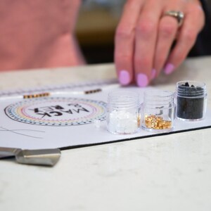 image of a person measuring the length of a bracelet with the in-built measuring tape of the wipeable bead mat. 






Wipeable Bead Mat with Built-in Measuring Tape | Non-Slip Jewelry Making Tool | Perfect Beading Mat for DIY Projects
