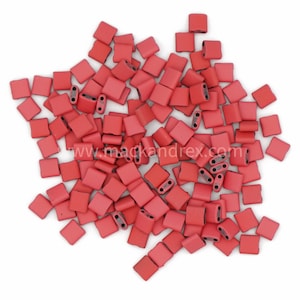 May include: A pile of small, red, square-shaped beads with two holes in each bead.