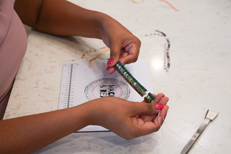image of a person making a bracelet while the wipeable bead mat is on the table. 







Wipeable Bead Mat with Built-in Measuring Tape | Non-Slip Jewelry Making Tool | Perfect Beading Mat for DIY Projects