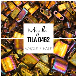 May include: A close-up image of a pile of iridescent gold and bronze Miyuki Tila beads. The beads are both whole and half beads. The text "Miyuki TILA 0462 WHOLE & HALF" is visible in the image.