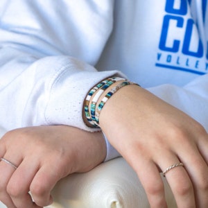 a person holding onto a white object with a ring on it