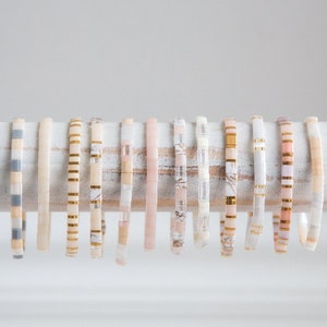 a row of bracelets sitting on top of a white curtain