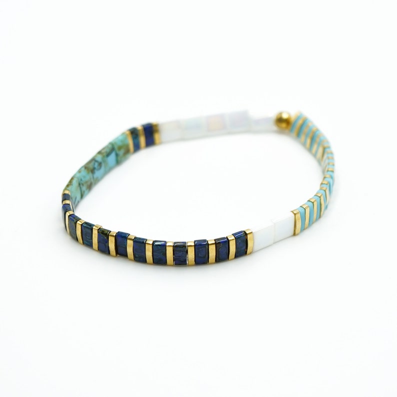 a blue and white beaded bracelet on a white background













Shoreline Mix & Match Tila Bead Bracelets for Women | High Quality Stacking Bracelet | Boho Stretch Bracelet | Waterproof Miyuki Tila Beads