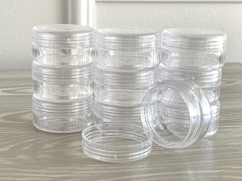 image of the Round Bead Containers 25-Pack on a table. 






Round Bead Containers 25-Pack | Clear Plastic Storage Jars with Twist Lids, 1.5 Inch Diameter Bead Storage Box for Jewelry & DIY Craft Kits