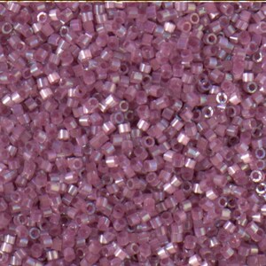 May include: Close-up of a pile of small, cylindrical beads in a soft, dusty rose color. The beads have a slightly iridescent sheen, catching the light. These beads are likely used for jewelry making or other craft projects.