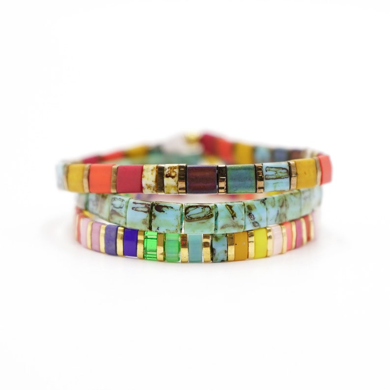 a stack of multicolored bracelets on a white background