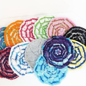 May include: A collection of colorful knitted dishcloths in various patterns, including stripes, swirls, and geometric designs. The dishcloths are made of soft, absorbent yarn and are perfect for cleaning dishes and other surfaces.