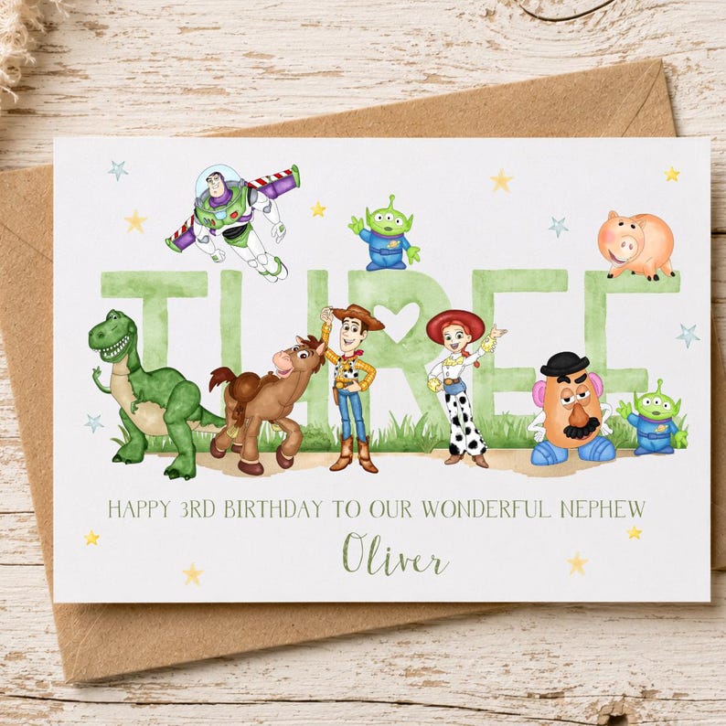May include: A white birthday greeting card featuring the word THREE in large green letters, decorated with illustrations of Buzz Lightyear, Rex, Bullseye, Woody, Jessie, Mr. Potato Head, and two aliens. Text reads: HAPPY 3RD BIRTHDAY TO OUR WONDERFUL NEPHEW Oliver.