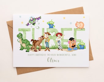 May include: A white card with a green, yellow, and red "THREE" spelled out with characters from the Toy Story movie. The characters include Woody, Buzz Lightyear, Rex, Jessie, Mr. Potato Head, and Alien. The card says "Happy Birthday to our wonderful son Oliver".
