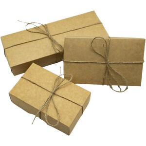 three brown boxes tied with twine and tied with twine