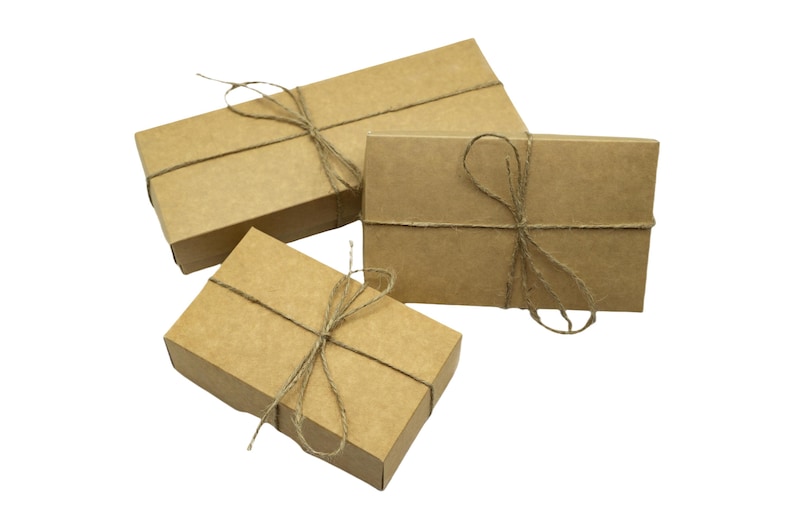 three brown boxes tied with twine and tied with twine