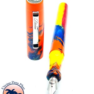 May include: A colorful fountain pen with an orange cap and a marbled barrel in shades of yellow, blue, and orange. The cap is off, revealing the nib. The pen is labeled "Divine" and the logo of "Divine Pens Plus Palm Bay, FL" is in the lower left.