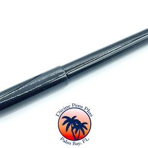 May include: A black pen with a speckled design. The pen has a cap and a cylindrical body. The pen is from Divine Pens Plus, Palm Bay, FL.