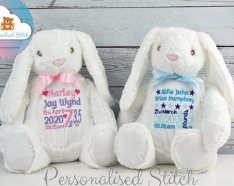 May include: Two white plush bunny rabbits with embroidered details. The pink bunny has a pink bow and is embroidered with "Harley Jay Wynd 11th April 2020 7.35 08.15am". The blue bunny has a blue bow and is embroidered with "Alfie John Brian Humphrey 21st March 2020 8.9 pounds 00.05 am".
