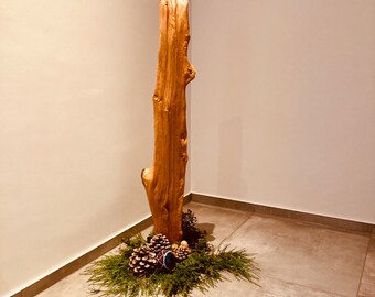 Wooden sculpture made from split oak on a stone base