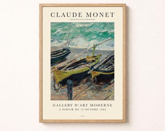 May include: A framed art print featuring a Claude Monet painting of boats on a shore. The text reads CLAUDE MONET, COLLECTION D'ART INTERNATIONAL, GALLERY D'ART MODERNE, and A PARTIR DE 19 OCTOBRE 1886. The wooden frame surrounds the cream-colored poster.
