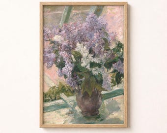 May include: A framed oil painting depicting a bouquet of purple and white lilac flowers arranged in a dark, rounded vase. The floral arrangement sits on a light-colored surface near a window, with soft pink and green tones visible in the background.