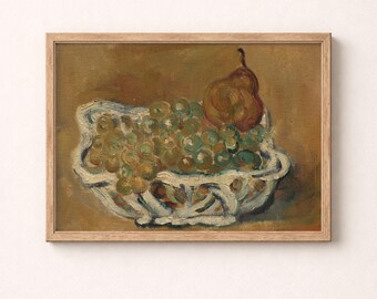 May include: A framed oil painting depicting a still life of a white, textured bowl filled with green grapes and a single brown pear. The artwork features visible brushstrokes and a muted, earthy brown background, all encased in a light wood frame.