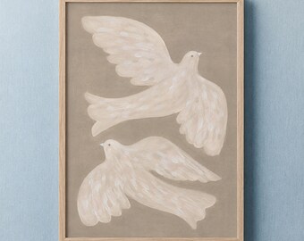 May include: A framed wall art print featuring two cream-colored birds in flight against a solid taupe background. The birds are rendered with soft, visible brushstrokes, and the artwork is enclosed in a simple, light-toned wooden frame.