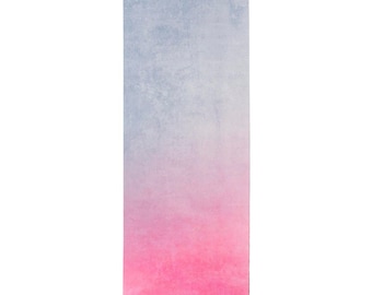 May include: A yoga mat with a gradient design, transitioning from a light blue to a pink color. The mat has a textured surface and the text "gosipaw athletes" is printed on the bottom right corner.