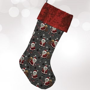 May include: A red and gray Christmas stocking with a Santa Claus pattern. The stocking has a red velvet cuff and a black loop at the top.