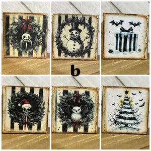 May include: Set of six square wooden signs with black and white striped backgrounds. Each sign features a different holiday-themed illustration, including a snowman, a bat, a skull, a Christmas tree, and a present.