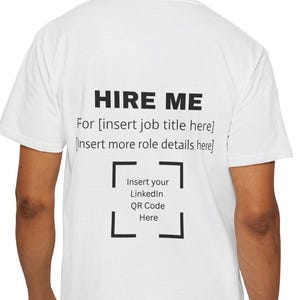 May include: White t-shirt with the text "HIRE ME" in black, followed by prompts to insert job title, role details, and a LinkedIn QR code. The shirt is worn by a person in blue jeans.