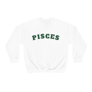 May include: White sweatshirt with a green "Pisces" graphic printed on the front.