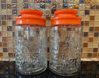 Vintage Anchor Hocking Tang Lilly of the Valley Cannisters ~ Set of 2 ~ Anchor Hocking ~ Glass Jar ~ Tang ~ Sight Cracking on One Orange Lid