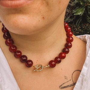 Bold Red Beaded Statement Necklace with Gold-Toned Toggle Clasp.
