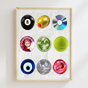 May include: A framed collage of nine different circular objects, including a billiard ball, a green olive, a CD, a rotary phone dial, a glass of iced tea, a tennis ball, a blue evil eye charm, a clear crystal ball, and a pink can.