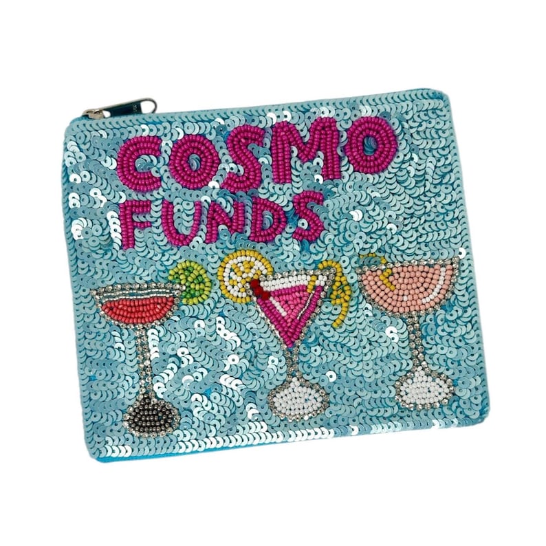 May include: A light blue sequined cosmetic bag with the words "COSMO FUNDS" in pink beaded letters. The bag features beaded cocktail glasses in red, pink, and peach. A fun accessory for storing makeup or small items.