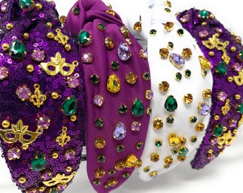May include: Four colourful headbands with a Mardi Gras theme. The headbands are decorated with sequins, rhinestones, and beads in purple, gold, and green.