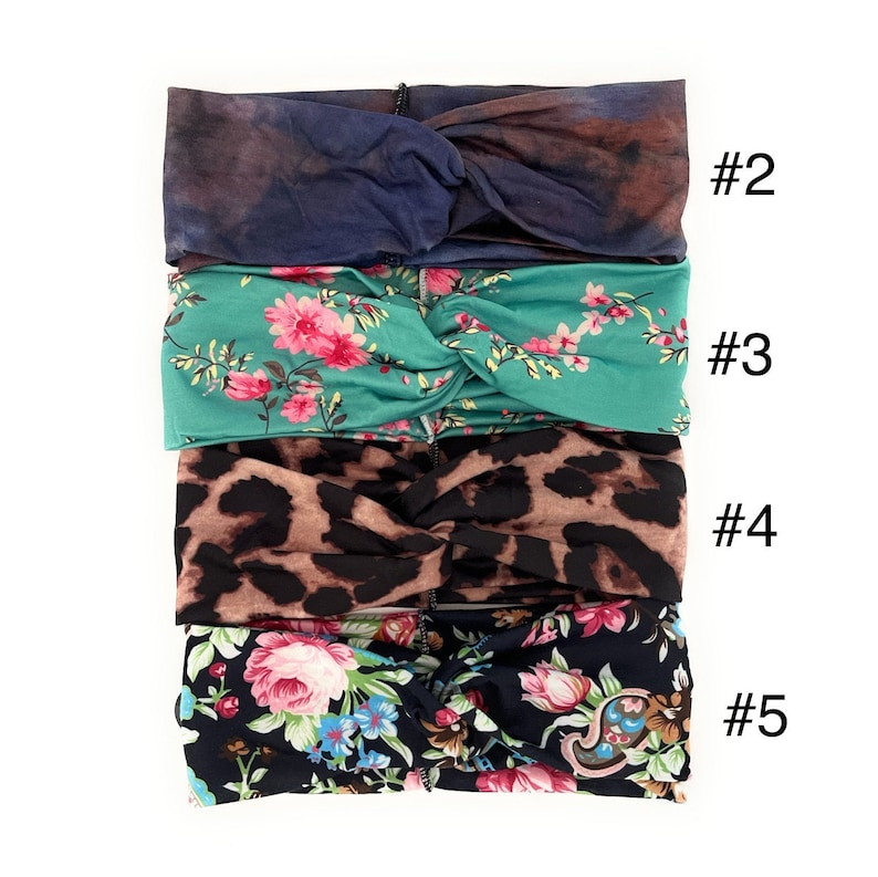 May include: Four different patterned headbands, stacked on top of each other. The top headband is a dark blue and purple tie-dye pattern. The second headband is a teal green with a pink floral pattern. The third headband is a brown and black leopard print. The bottom headband is a black background with a pink and blue floral pattern. The numbers 2, 3, 4, and 5 are written to the right of each headband.