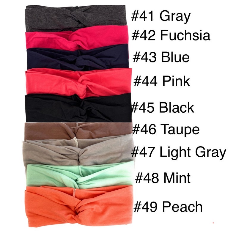 May include: A stack of nine knotted headbands in various colours, including grey, fuchsia, blue, pink, black, taupe, light grey, mint, and peach. Each headband is labelled with a number and colour name.