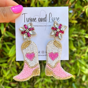 Handmade light pink cowgirl boots with a hear on the middle