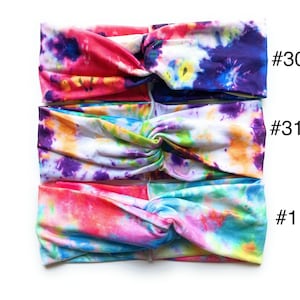 May include: Three tie-dye headbands in different colour combinations. The top headband is pink, purple, and yellow. The middle headband is white, purple, yellow, and green. The bottom headband is pink, blue, and yellow. The headbands are labelled #30, #31, and #1.