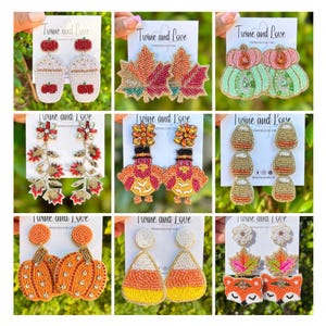 May include: A collection of beaded earrings with fall and autumn themes. Designs include pumpkins, maple leaves, coffee cups, turkeys, acorns, candy corn, and foxes. Each pair of earrings is displayed on a white card with the text "Twine and Love".
