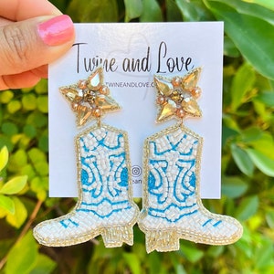 Handmade blue and white cowgirls boots with a gold border.