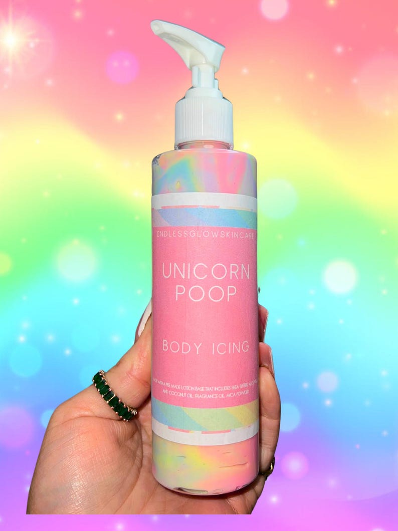 May include: A pink and white body icing bottle with a white pump dispenser. The label reads "Unicorn Poop Body Icing" with the Endless Glow Skincare logo. The background is a rainbow gradient.