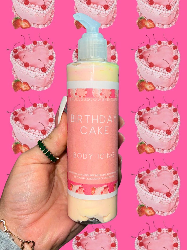 May include: A clear bottle of "Birthday Cake Body Icing" lotion with a light blue pump. The bottle has pink and white labels with text and a pink background with heart-shaped cakes. The lotion is multi-colored.